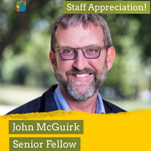 John McGuirk wearing blue glasses and smiling wide. Text: Staff Appreciation! John McGuirk, Senior Fellow