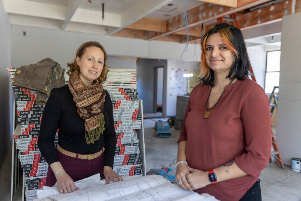 Dr. Charlotte Hajer and Dr. Sita-Marie Pillay look at plans of new Mental Health Hub at Hanna Center