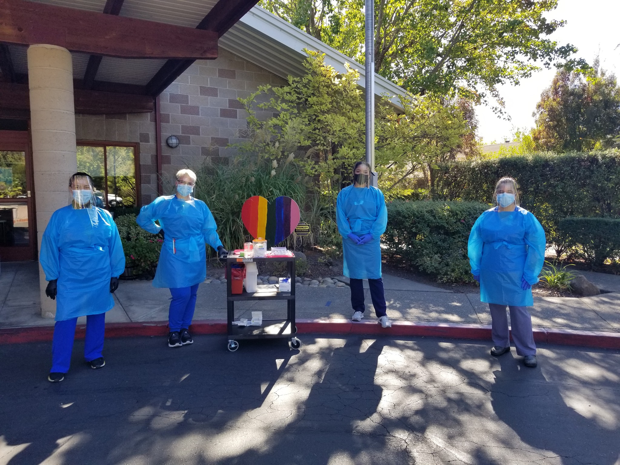 Sonoma Valley Community Health Center employees gathered outside wearing protective medical gear.