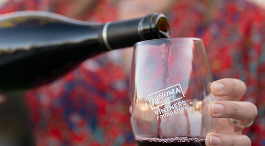 Wine being poured into a glass. Text: Sonoma County Vintners Foundation