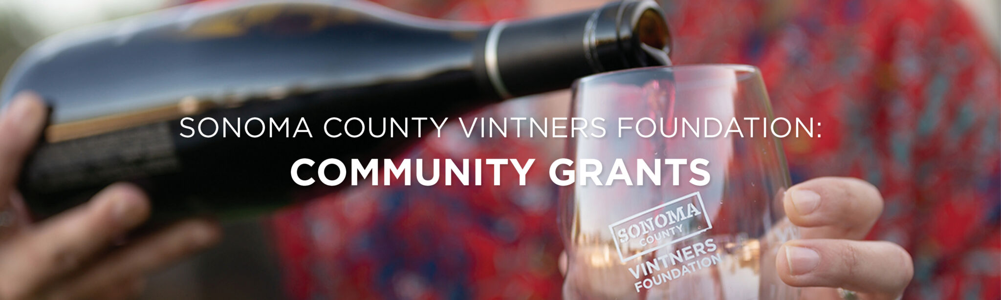 Wine being poured into a glass. Text: Sonoma County Vintners Foundation Community Grants program