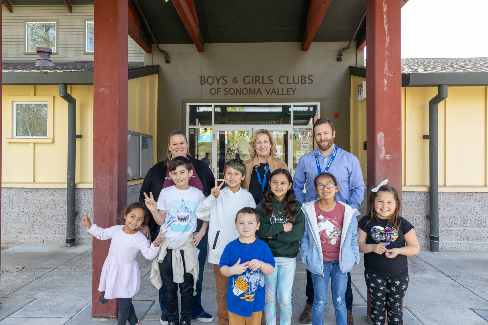 A group of youth standing in front of the Boys & Girls Clubs of Sonoma Valley alongside staff.
